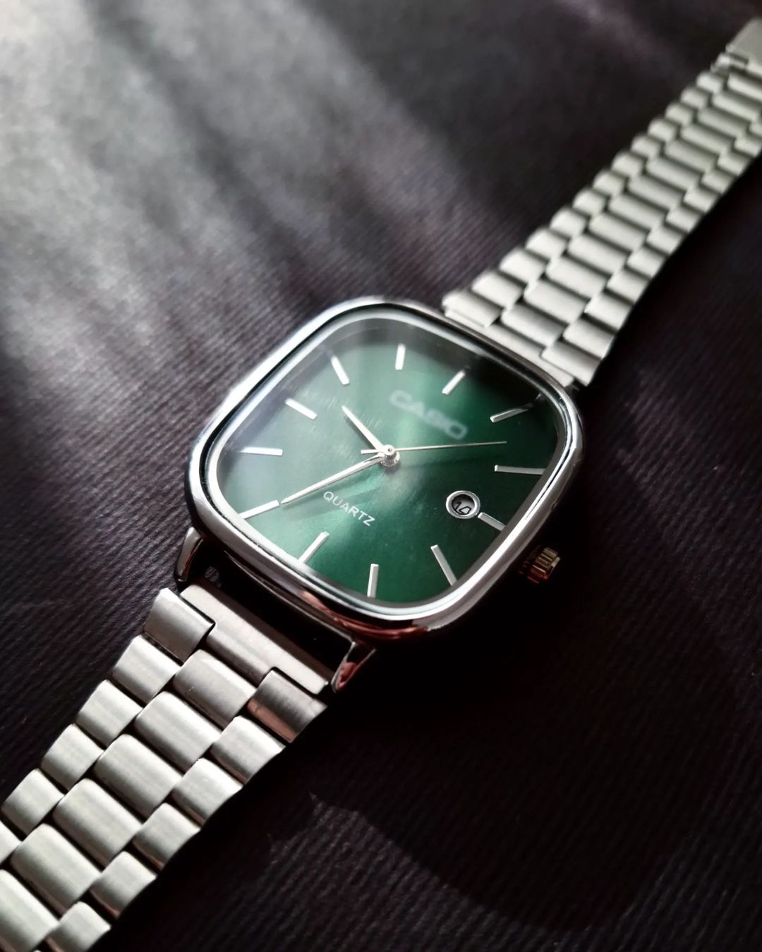 Casio - Silver with a green dial